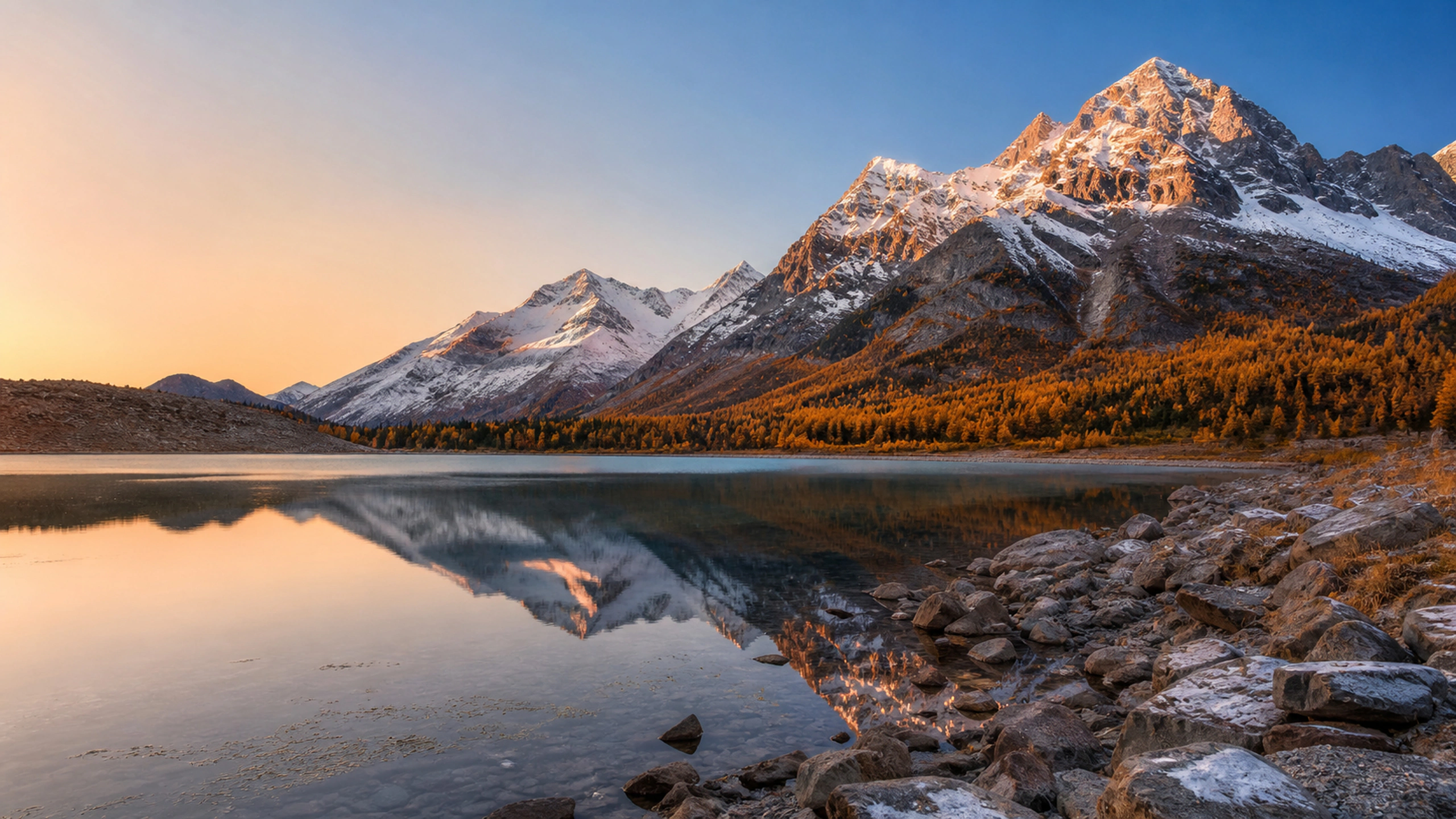 Fresh overnight snow on dark peaks above an autumn valley, crisp sunrise atmosphere, original 4K nature wallpaper