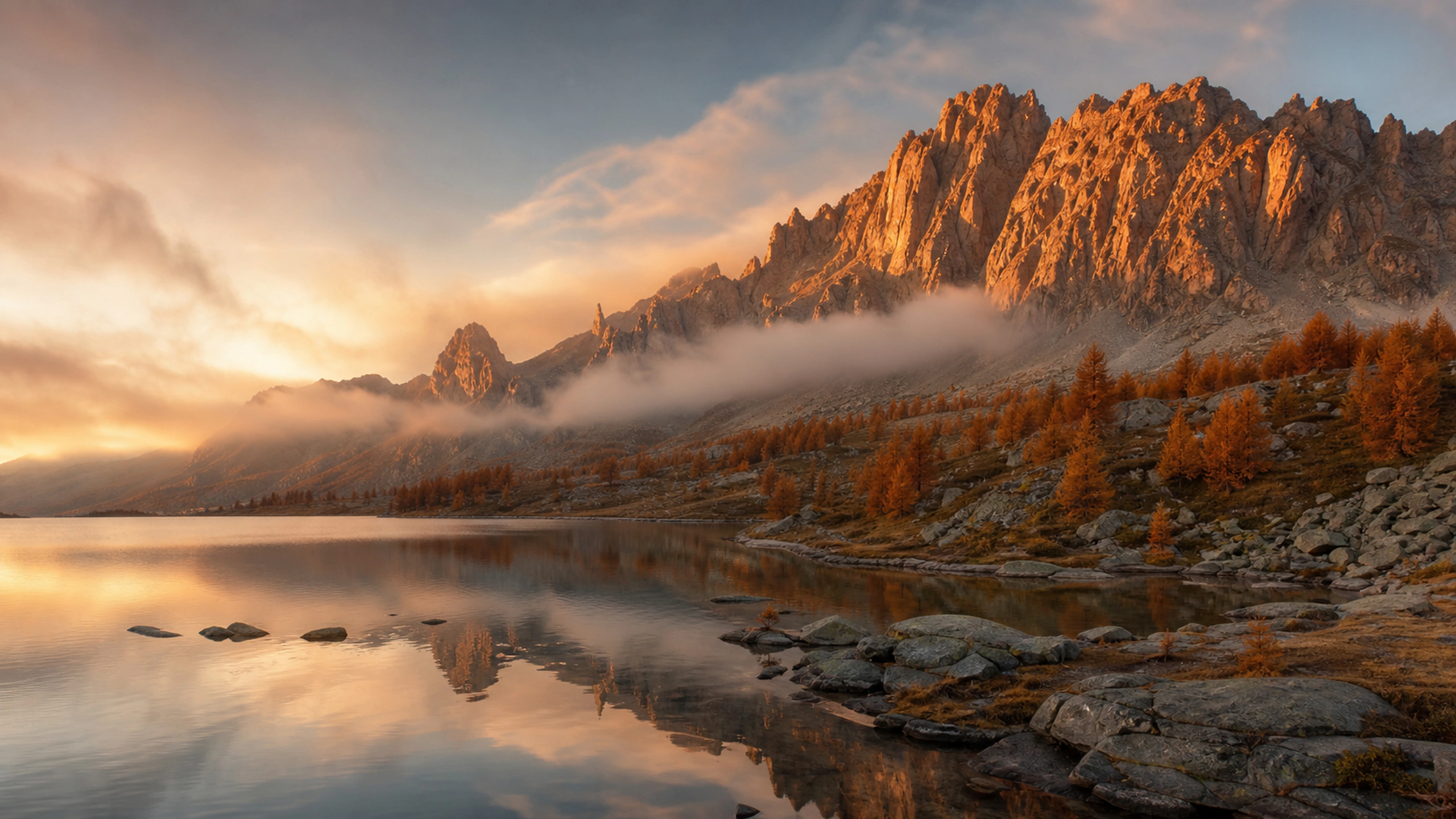 Late-autumn larches and granite peaks under deep amber sunrise, crisp mountain air, original 4K mountains wallpaper