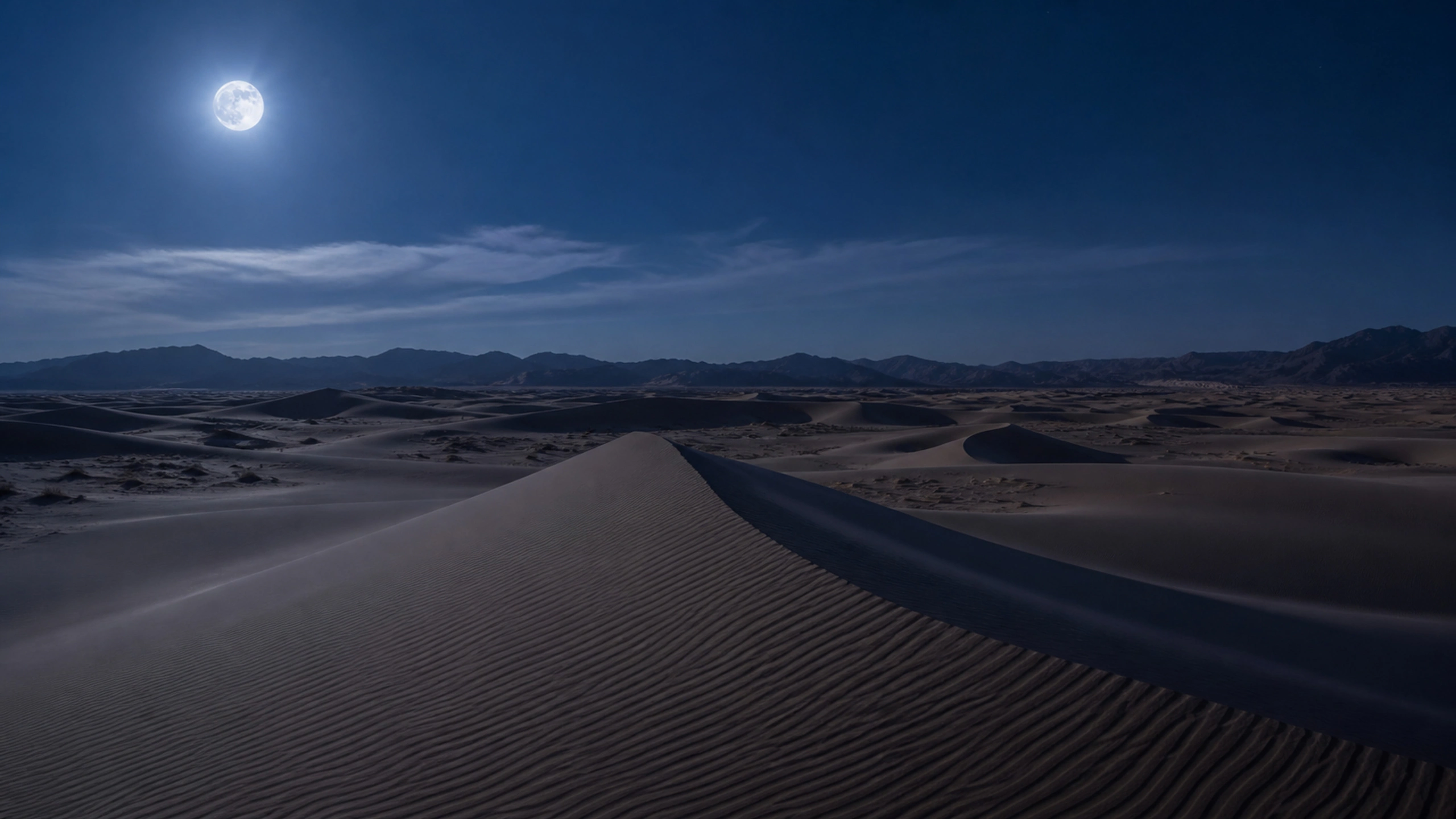 Blue moonlight over a vast dune sea with crisp ridgelines and no artificial glow, original 4K desert wallpaper