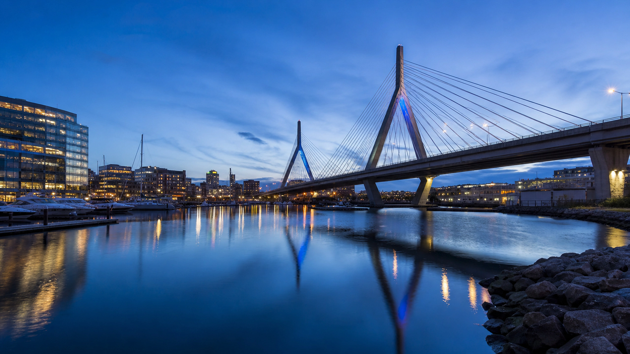Elegant original bridge crossing a harbor basin with subdued city lights, original 4K cities wallpaper