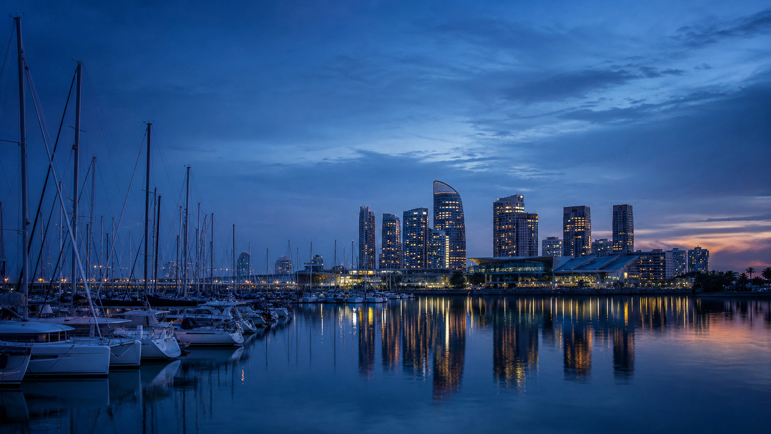 Rows of unbranded sailboats and an original skyline reflected in still blue-hour water, original 4K cities wallpaper