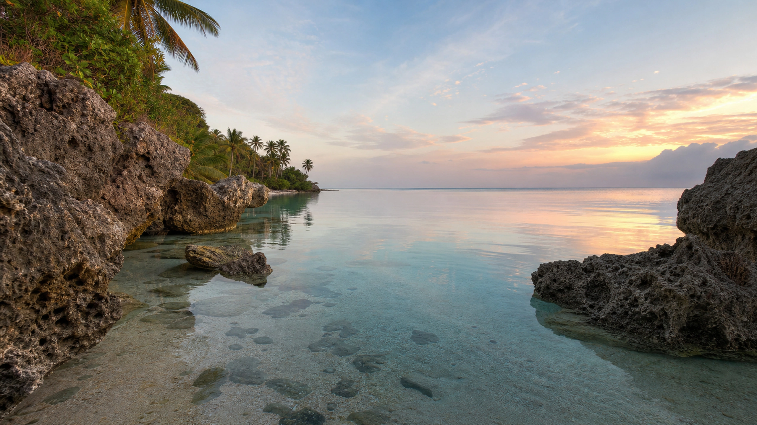 Weathered limestone stacks enclosing glassy water at first light, original 4K beaches wallpaper