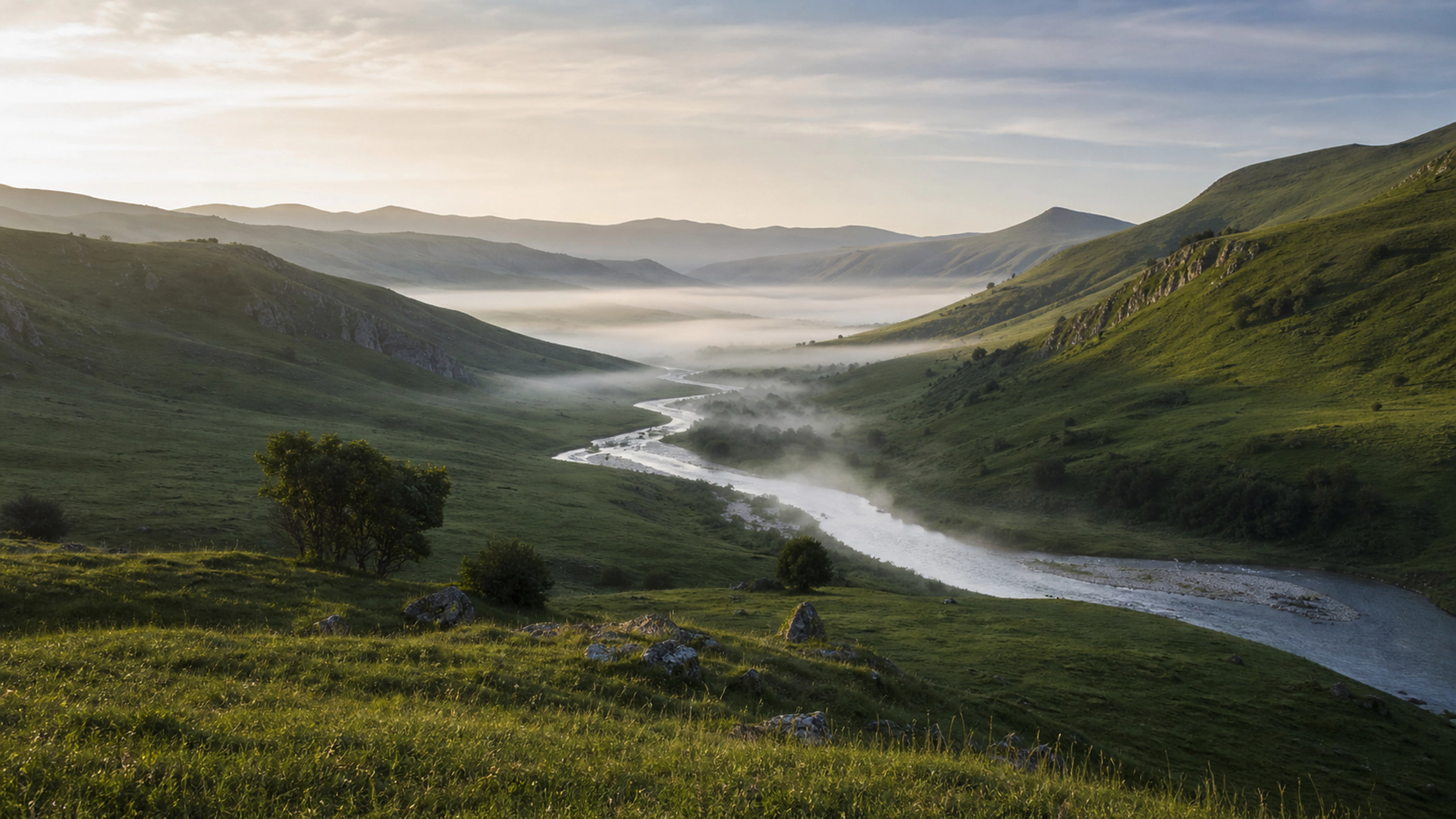 Green valley river disappearing through low silver morning mist, original 4K nature wallpaper
