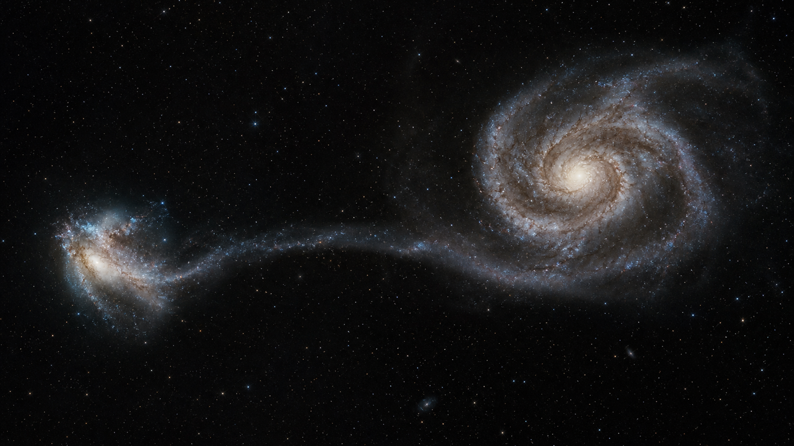 Two interacting galaxies separated across the frame, with a larger spiral pulling a long faint tidal tail toward a smaller irregular companion, original 4K space wallpaper