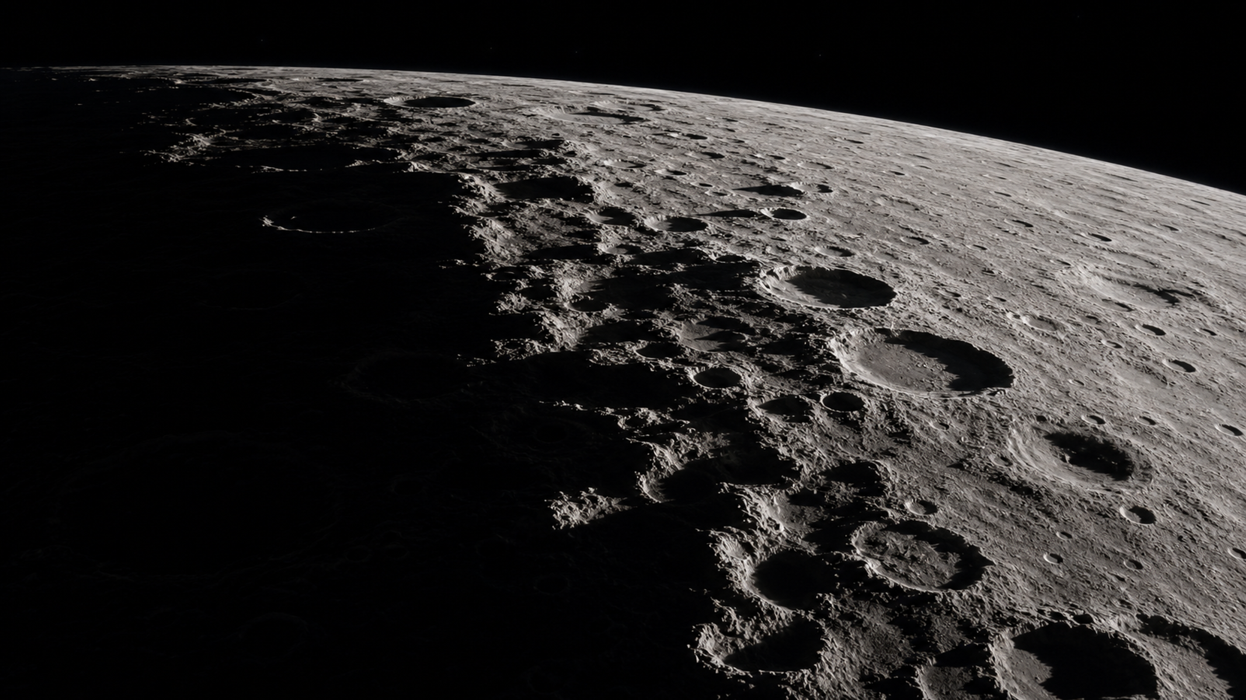 A wide view along the Moon's terminator where sunlight cuts diagonally across overlapping crater rims and deep shadow, original 4K planets wallpaper