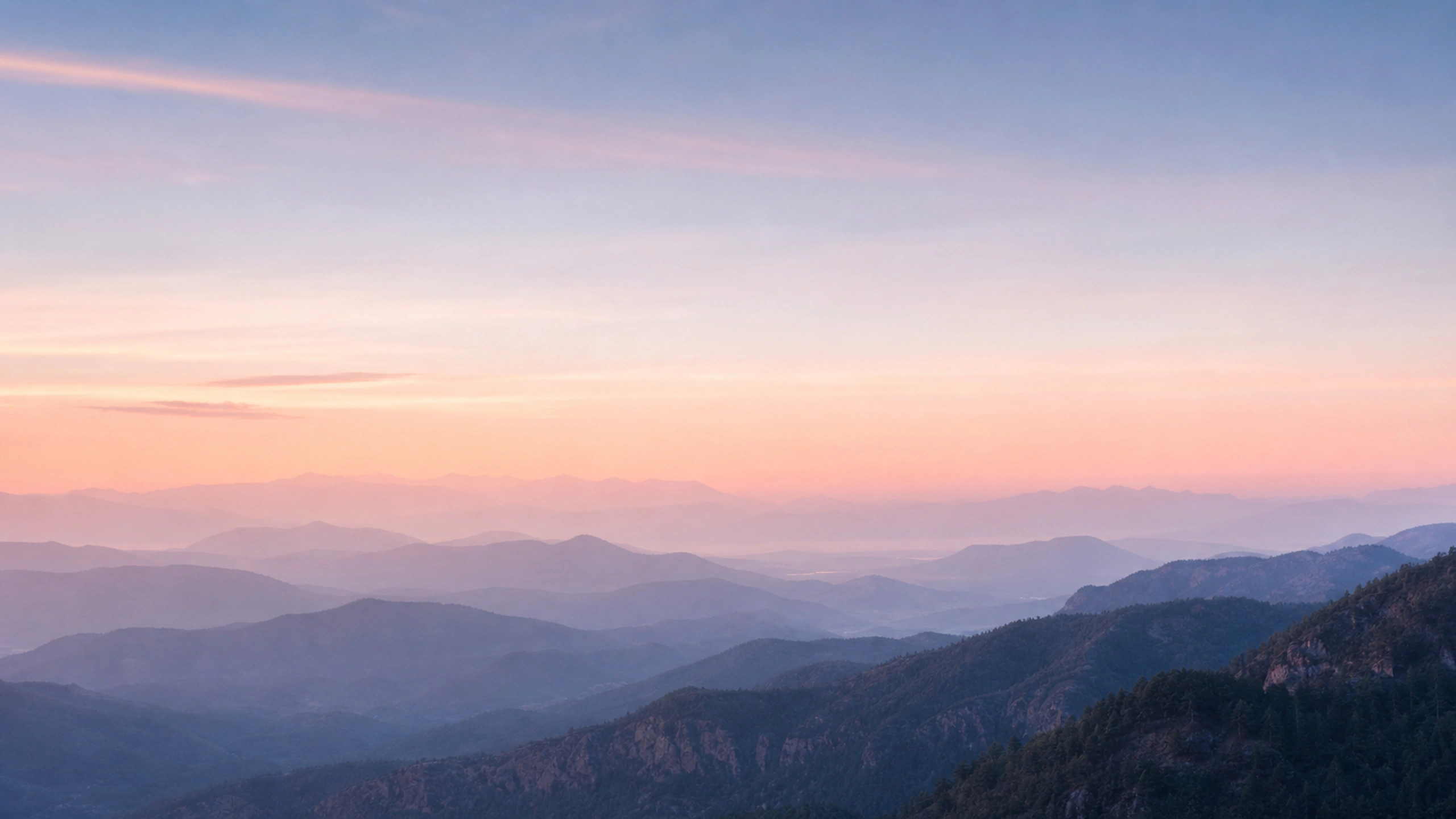 Soft layered hills reduced by dawn haze beneath a peach-blue sky, original 4K pastel wallpaper