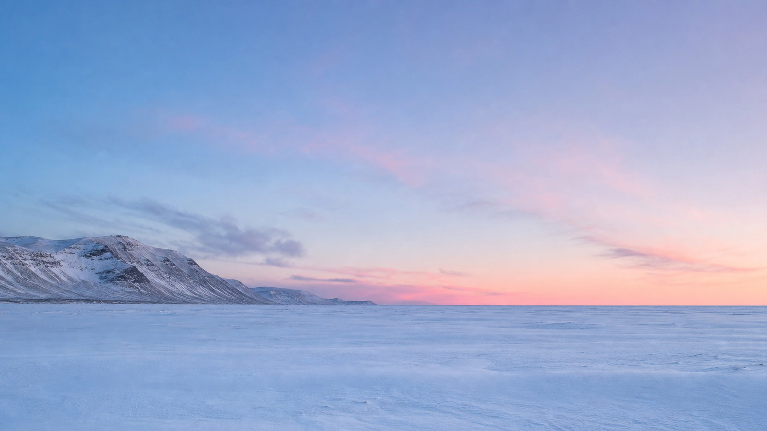 Minimal snow field beneath powder-blue and faint rose winter light, original 4K pastel wallpaper