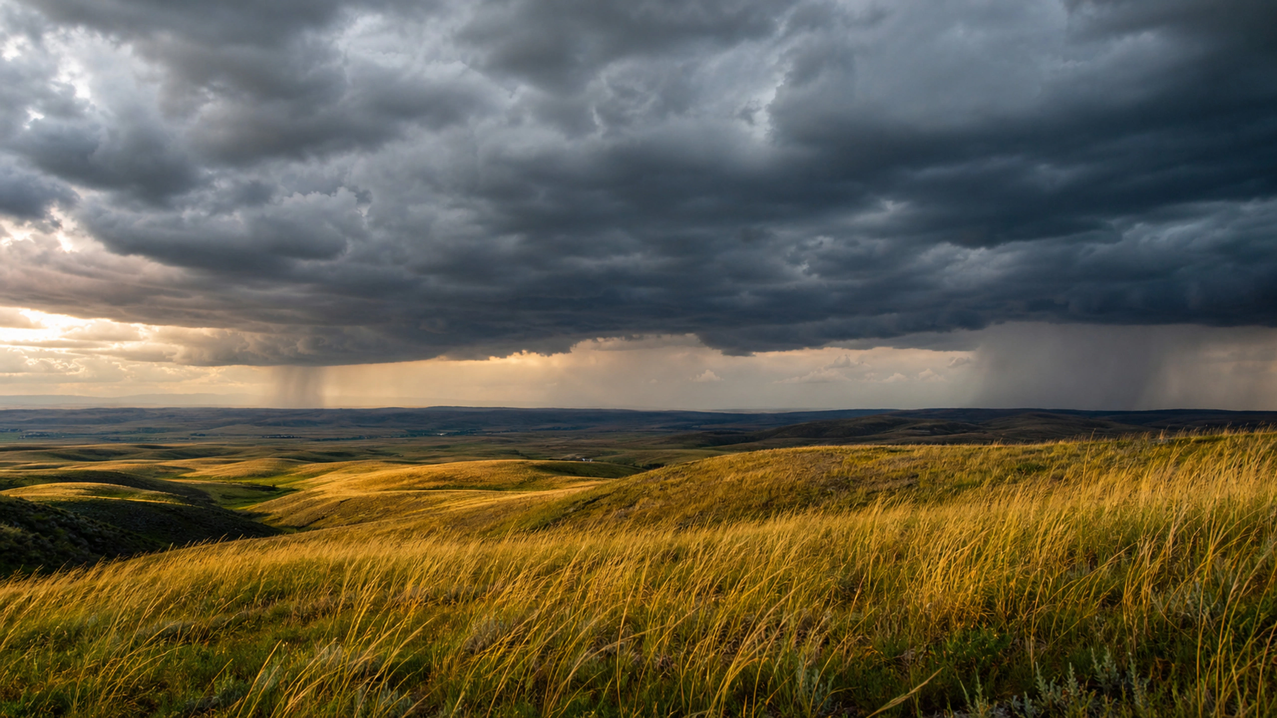 Two separated thunderstorms over layered rolling plains, meteorologically believable, original 4K weather wallpaper