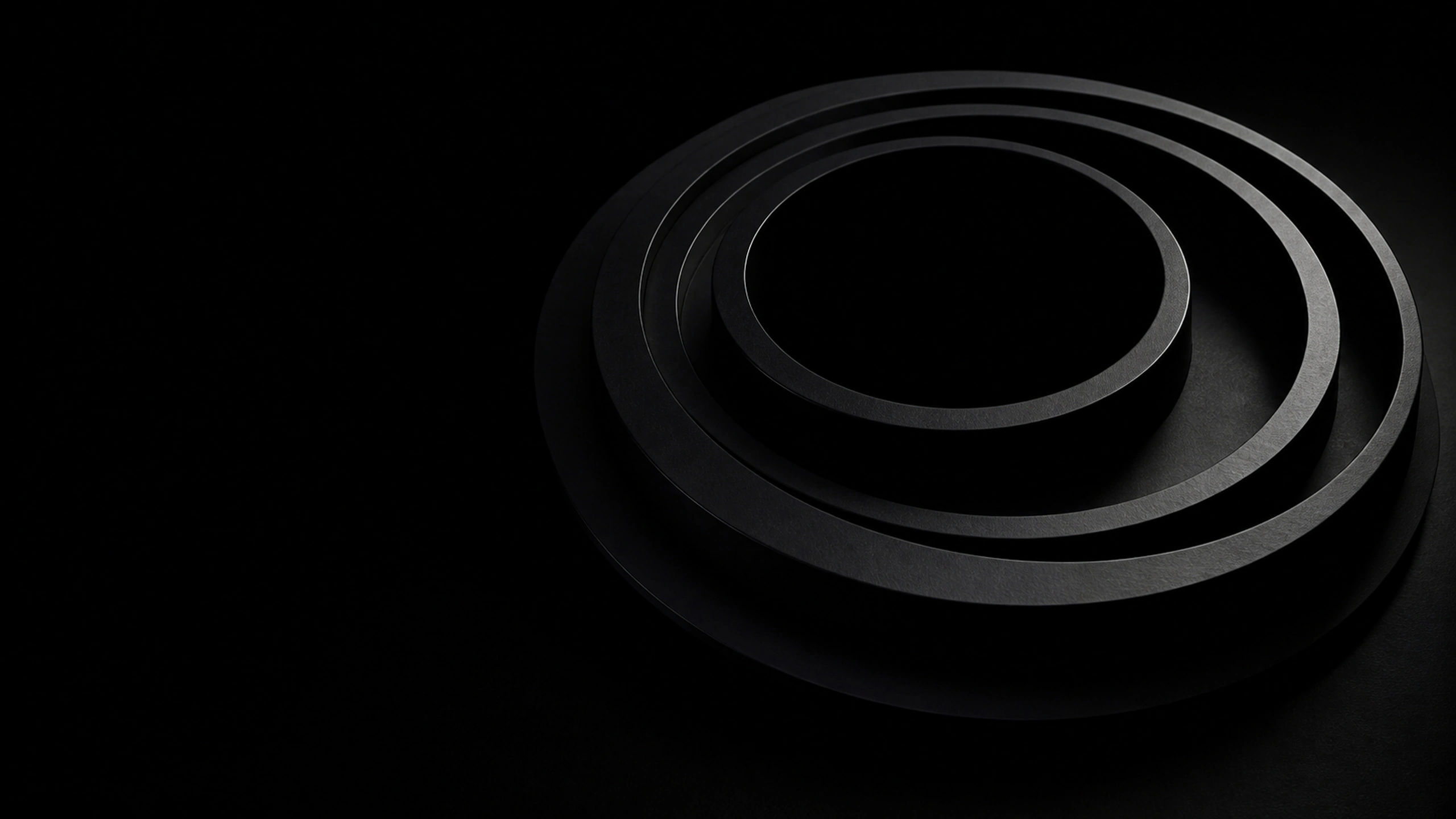 Original concentric matte-black sculptural rings around a total eclipse, precise grazing rim light and asymmetric studio composition, original 4K dark amoled wallpaper