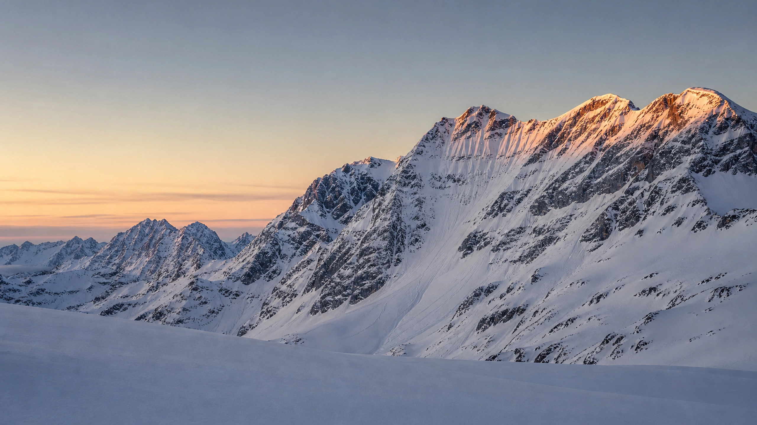 Remote mountain face with realistic old avalanche tracks and untouched foreground, original 4K mountains wallpaper