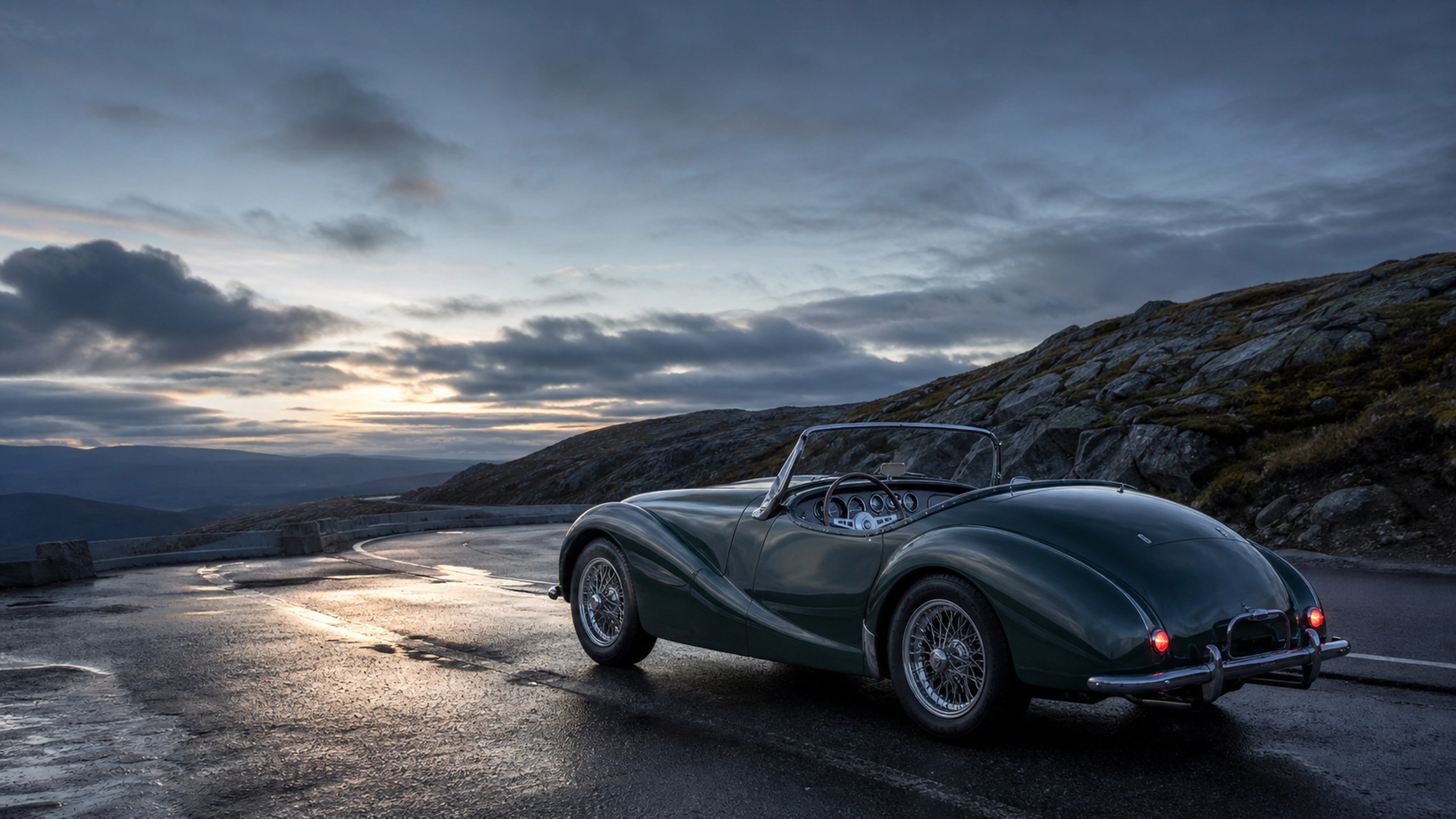 Original compact roadster on an empty generic city street after rain at blue hour, original 4K vehicles machines wallpaper