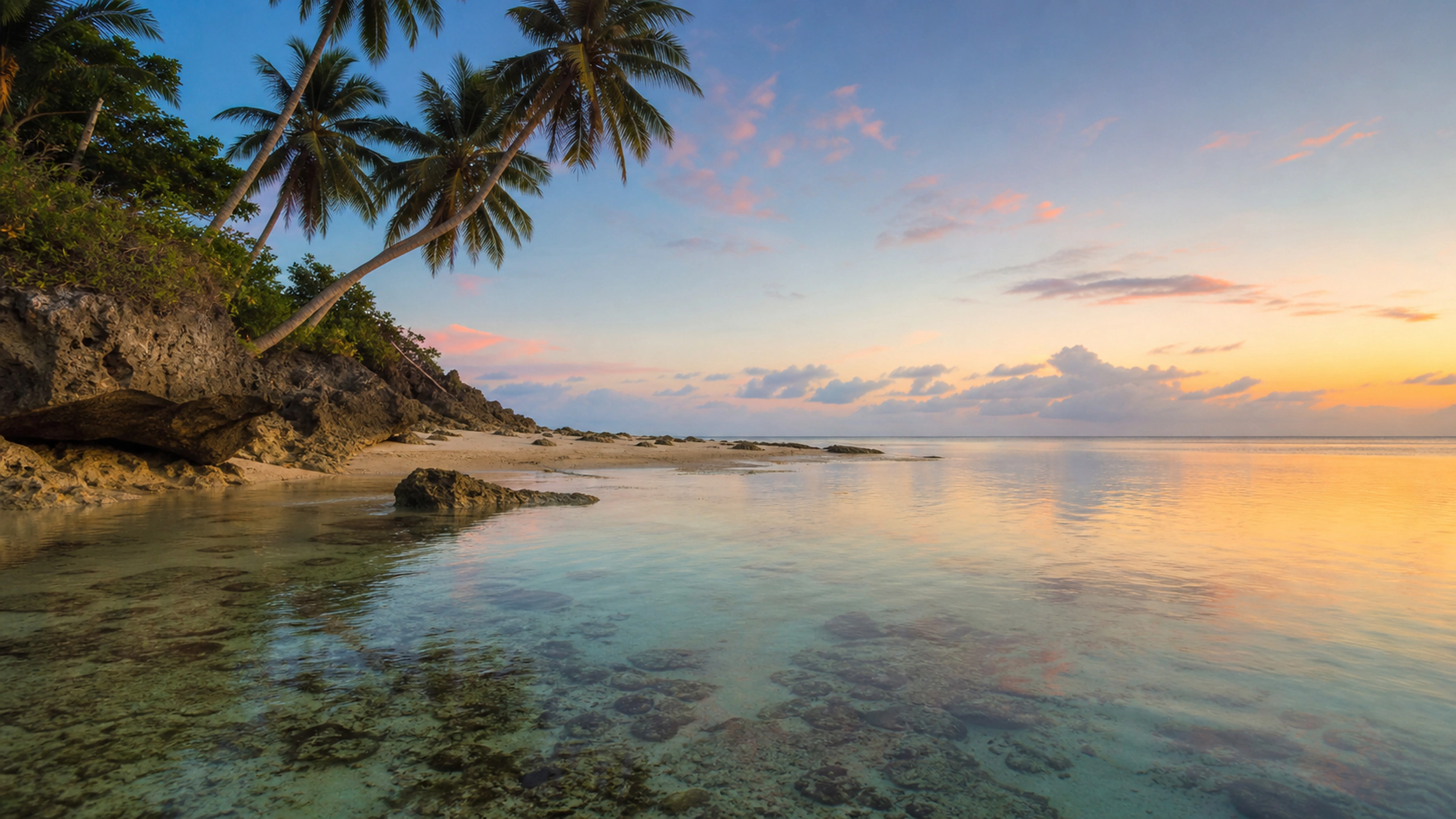 Quiet natural lagoon reflecting restrained coral evening light without structures, original 4K beaches wallpaper